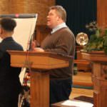 Reverend Speaking With Students At The Front